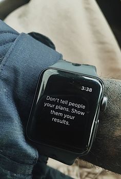 a person wearing a smart watch with a quote on the screen that says, don't tell people your plans show them your results