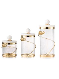 three glass containers with gold trim and pearls