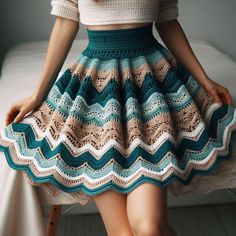 a woman is wearing a skirt with crochet on it