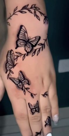 a woman's hand with butterflies on it