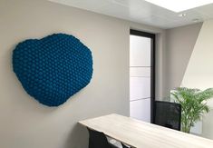 a large blue heart on the wall in an office