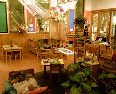 a living room filled with lots of furniture and plants