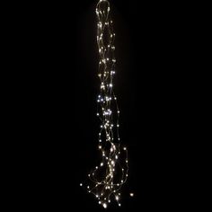 a long string of lights hanging from the side of a building in the night time