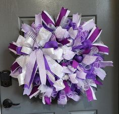 a purple and white wreath on the front door