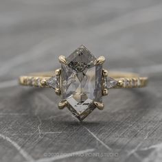 an engagement ring with three stone accents on the sides and two diamonds in the middle