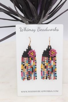 Add a pop of color to your outfit with these handcrafted beaded seed bead earrings! Measuring just over 2 inches long, these unique earrings feature bright colors perfect for adding a playful touch to any look. The floral accent adds a touch of whimsy, and the fringe detail adds a fun and trendy flair. Stand out from the crowd with these vibrant and stylish earrings that are sure to make a statement wherever you go.Lightweight and comfortable to wear. Each tiny bead is sewn into place one at a time with a needle and strong beading thread creating a piece of wearable art.✔️handmade in the USA✔️lightweight & comfortable ✔️golden brass ear wires (we also offer the option of gold filled or niobium ear wires if needed-just message us)✔️2 3/8 inches long ✔️3/4 inch wide✔️ships boxed and ready to Multicolor Beaded Drop Flower Earrings, Multicolor Beaded Flower Drop Earrings, Summer Multicolor Jewelry With Black Beads, Multicolor Jewelry With Black Beads For Summer, Colorful Adjustable Heishi Beaded Earrings, Summer Black Beaded Earrings, Adjustable Multicolor Flower Earrings With Colorful Beads, Multicolor Heishi Beads Earrings With Ear Wire, Beaded Multicolor Flower Earrings For Summer