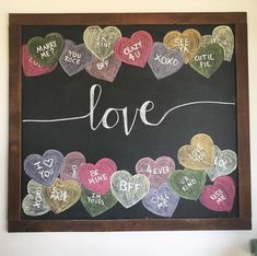 a chalkboard with hearts and words written on it that spell out the word love