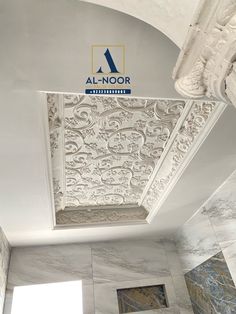 the ceiling in this bathroom is decorated with white marble