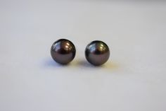 The size of the round Japanese Akoya black pearls are approximately 7x6.5mm with high luster. The color is black to dark grey, but has a pinkish purple overtone. They are set in 14K yellow gold post and backing. All inventory is in stock and ready to be shipped once we have received payment. You will receive black pearls are close as to the ones photographed. For more information, Like us on Facebook, follow us on Instagram or visit our website www.ikedapearl.com If you have any questions or inq Pinkish Purple, Black Pearls, Freshwater Pearl Ring, First Photograph, Gold Birthday, Stud Set, Favorite Rings, Pearl Studs, Black Pearl