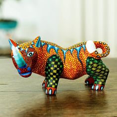 a small ceramic animal sitting on top of a wooden table