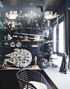 a display case with star wars figurines and action figures on it's glass shelves