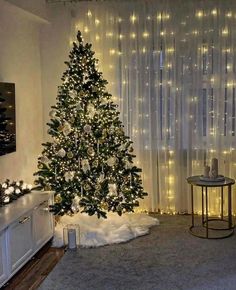 a living room with a christmas tree in the corner and lights on the wall behind it