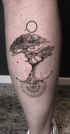 a man's leg with a tree on it and an eye in the middle