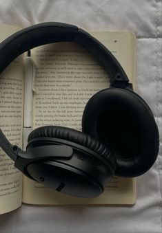 headphones resting on top of an open book