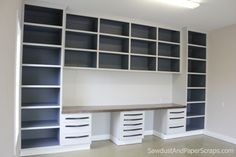 an empty room with shelves and drawers