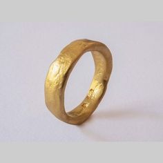 a close up of a gold ring on a white surface