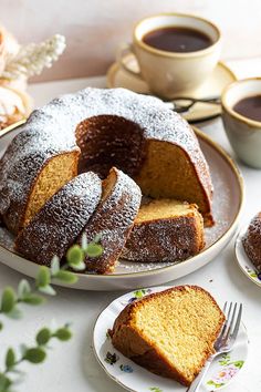 a bundt cake with powdered sugar on top and two slices cut from it