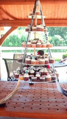 cupcakes are arranged in the shape of a christmas tree on a table with ribbon