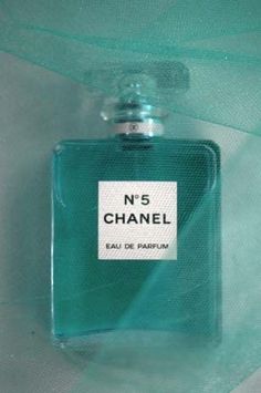 a bottle of chanel n'5 perfume sitting on top of a green cloth