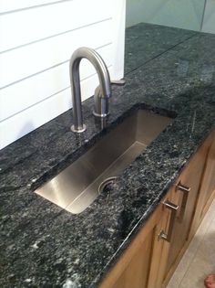 a stainless steel sink sitting on top of a counter