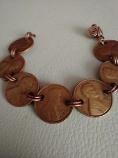 a bracelet made out of two penny coins