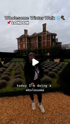 a woman standing in front of a large house