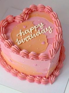 a heart shaped birthday cake with the words happy birthday written on it