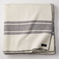 the white and grey striped blanket is folded up