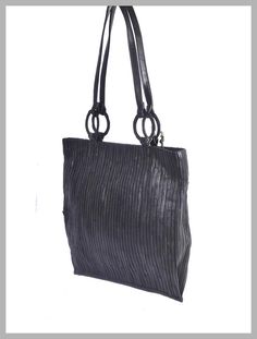 Unique, sleek, fun & fabulous. This leather shoulder tote handbag features various colored leather stripes, which, instead of being tossed to the waste heap, have been re-purposed to create a beautifully decorated 'Bamboo' accent. All will swoon when you step out with this beauty. A true statement piece, sunup to sundown. Style this tote with your favorite jeans or chic mini dress. Check out our sandals using the same metallic leather for a groovy pairing. A soft & durable canvas lining Evening Leather Shoulder Bag With Bamboo Handle, Leather Shoulder Bag With Bamboo Handle For Evening, Evening Rectangular Shoulder Bag With Bamboo Handle, Evening Satchel Shoulder Bag With Bamboo Handle, Evening Bags With Bamboo And Double Handle, Elegant Tote Shoulder Bag With Bamboo Handle, Evening Shoulder Bag With Bamboo Double Handle, Evening Bags With Double Bamboo Handle, Formal Tote Bag With Bamboo Handle