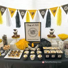 a graduation dessert table with cupcakes and snacks