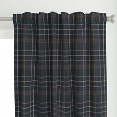 a black and brown plaid curtain hanging in front of a window