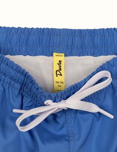 Our elastic Swim Shorts are your new go-to for leisurely days in the sun. These vintage trunks are made of 100% poly in a comfort short / wide fit. Every pair is equipped with a tearaway size tag for max waist comfort. Meet your new favorite beach trunk. Pair it with your favorite Duvin tee and hat. 100% Polyester Wide-leg relaxed fit Tearaway size tag 14.6'' size Medium outseam (scales up and down depending on size - we recommend sizing up if you want a little length 5'' inseam Premium soft box Blue Bottoms With Elastic Waistband For Swimming, Blue Poolside Shorts With Elastic Waistband, Blue Athletic Shorts For The Beach, Blue Shorts With Elastic Waistband For Poolside, Blue Athletic Shorts With Elastic Waistband For Beach Season, Blue Short Swim Trunks With Elastic Waistband, Summer Blue Athletic Shorts For Poolside, Blue Bottoms With Elastic Waistband For Pool, Blue Swim Trunks With Elastic Waistband