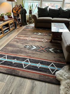 a living room filled with furniture and a large rug