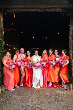 Bright vibrant orange bridesmaid dresses and suit for the bridal party wearing hot pink shoes Blue Bridesmaid Dresses Short, Bridesmaid Suits, Outdoor Pub, Hot Pink Shoes, Orange Bouquets, Frozen Margaritas, Bridal Party Outfit