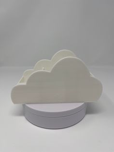 a white cloud shaped object sitting on top of a table