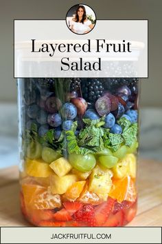 a jar filled with fruit sitting on top of a wooden table