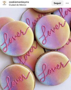 some cookies that have been decorated with the words love you more on them and are sitting next to each other