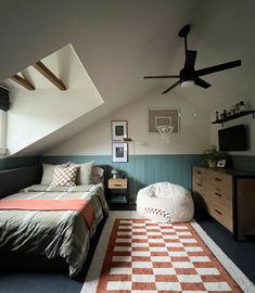 a bedroom with an orange and white checkered rug on the floor next to a bed