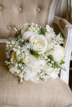 a bridal bouquet sitting on top of a chair