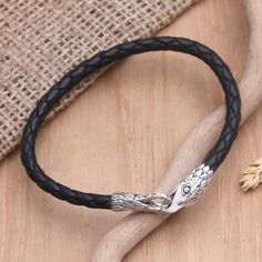 This innovative design by Nyoman Ariawan combines braided black leather with darkened sterling silver, each setting off the qualities of the other. The clasp is unique as well. At one end is an eagle's head, and on the other, there is a hook clasp with the same feathered design. When closed. It is reminiscent of the serpent that eats its own tail. Topaz Wedding Ring, Sterling Silver Bangle Bracelets, Bangle Bracelet Set, The Serpent, Eagle Head, Band Bracelet, Sterling Silver Dangle Earrings, Silver Bangle Bracelets, Sterling Silver Bangles