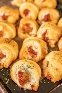 small pastries with meat and cheese on a baking sheet ready to be baked in the oven