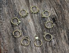 "Sellers tip : Buy more than 1 item from our shop to save shipping cost. Brass septum Ring, 9 Designs are suitable for other piercings as Helix, Tragos and more. These Fake Septum Rings not require a hole and comfortable for wearing. In above pictures you can see the number of each design, please select the desired design. Note:- These are not stock photos - these are actual photos taken of the item listed. However, since screen resolutions vary, the colors \"in-person\" may be slightly differen Adjustable Round Bohemian Nose Rings, Handmade Bohemian Round Nose Rings, Hypoallergenic Adjustable Septum Ring For Weddings, Bohemian Adjustable Septum Ring As Gift, Bohemian Adjustable Septum Ring Gift, Handmade Bohemian Round Septum Ring, Bohemian Handmade Round Septum Ring, Unique Adjustable Septum Ring, Nickel Free, Unique Adjustable Nickel Free Nose Rings