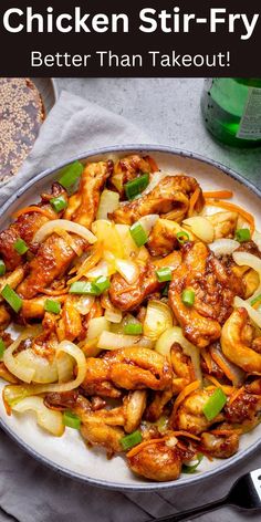 chicken stir fry with onions and green peppers in a skillet on a white plate