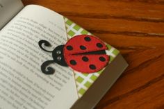 a ladybug brooch sitting on top of an open book