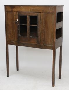 an old wooden cabinet with glass doors