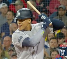 a baseball player holding a bat in front of a crowd