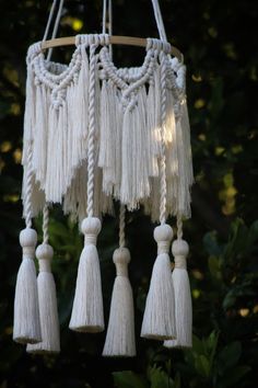 several white tassels hanging from a tree