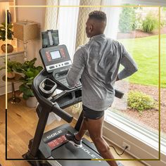 a man on a treadmill looking out the window