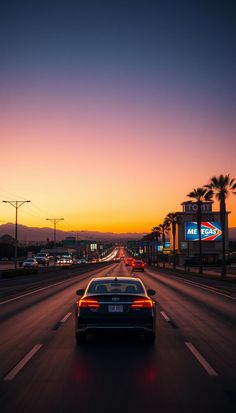 a car driving down the road at sunset