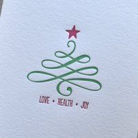 a white card with a christmas tree on it that says love, health, joy